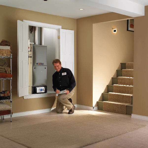 A Technician inspects a gas furnace