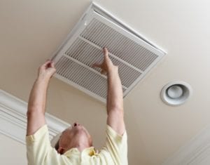 A technician replaces and air filter grille