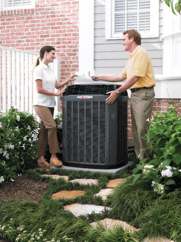 A service tech shows a Flower Mound homeowner the source of the problem