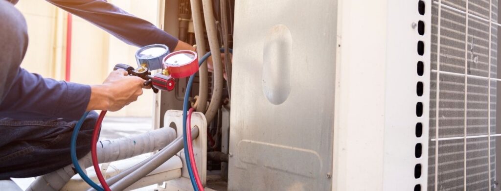 Air conditioning technician checking an air conditioning leak. 